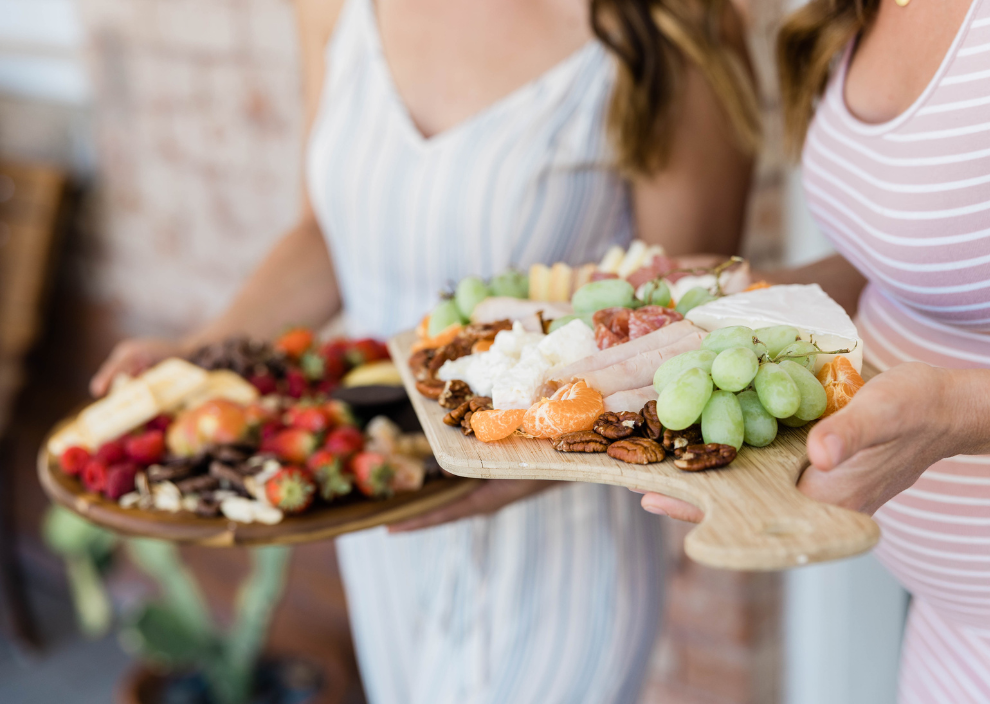 girls holding charcuterie plates