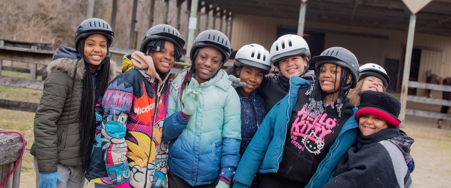 Group of smiling students posing together outdoors during Outdoor Education camp