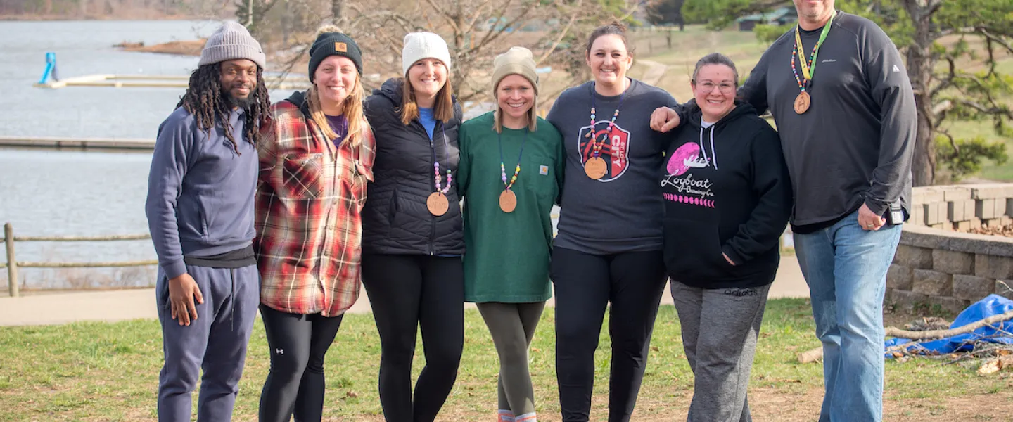 Group of teachers standing together and smiling during school retreat
