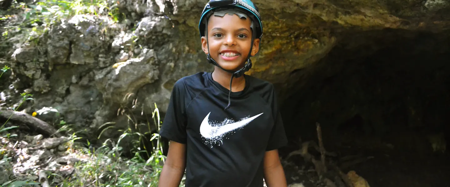 YMCA Camp Lakewood Camper wearing a helmet on a cave excursion 