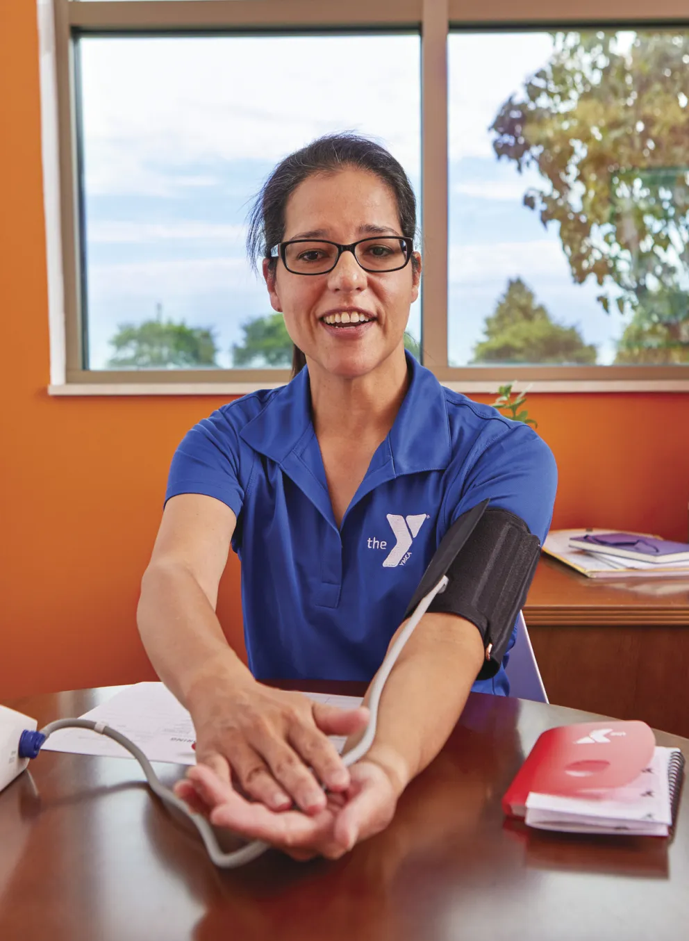 woman at the YMCA checking her blood pressure