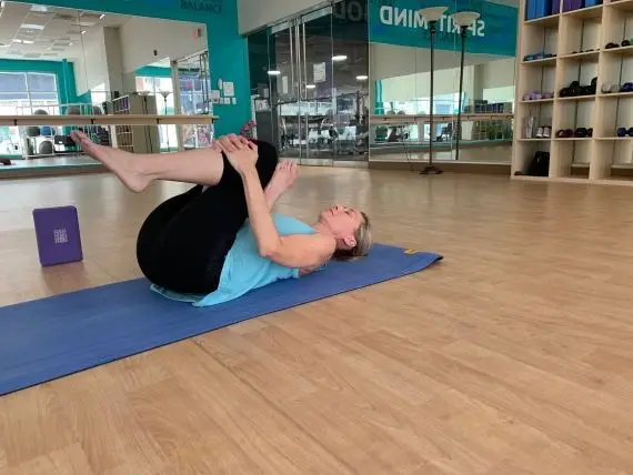 woman doing pigeon pose yoga