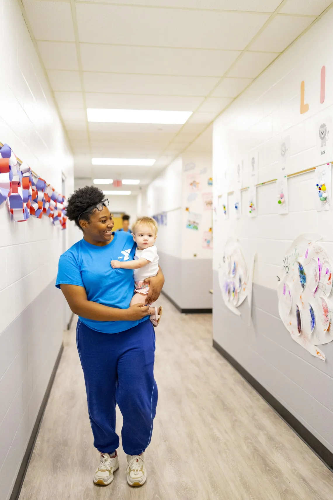 Edward Jones YMCA ECEC staff holding child