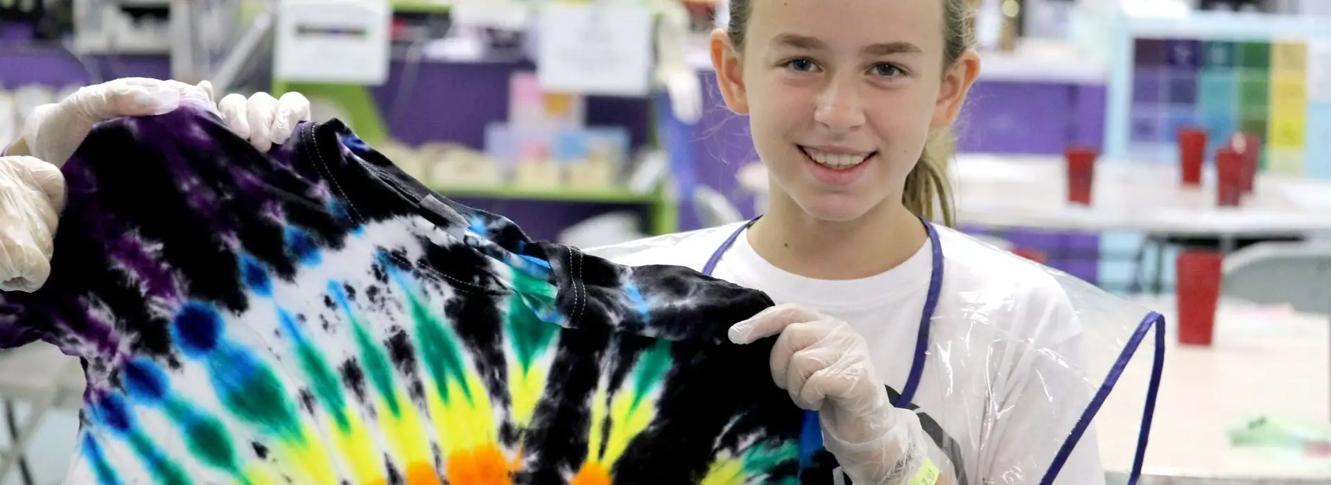 Teen girl tie dying a tshirt