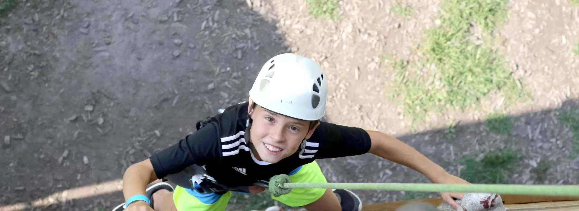 photo looking down on young boy starting to climb