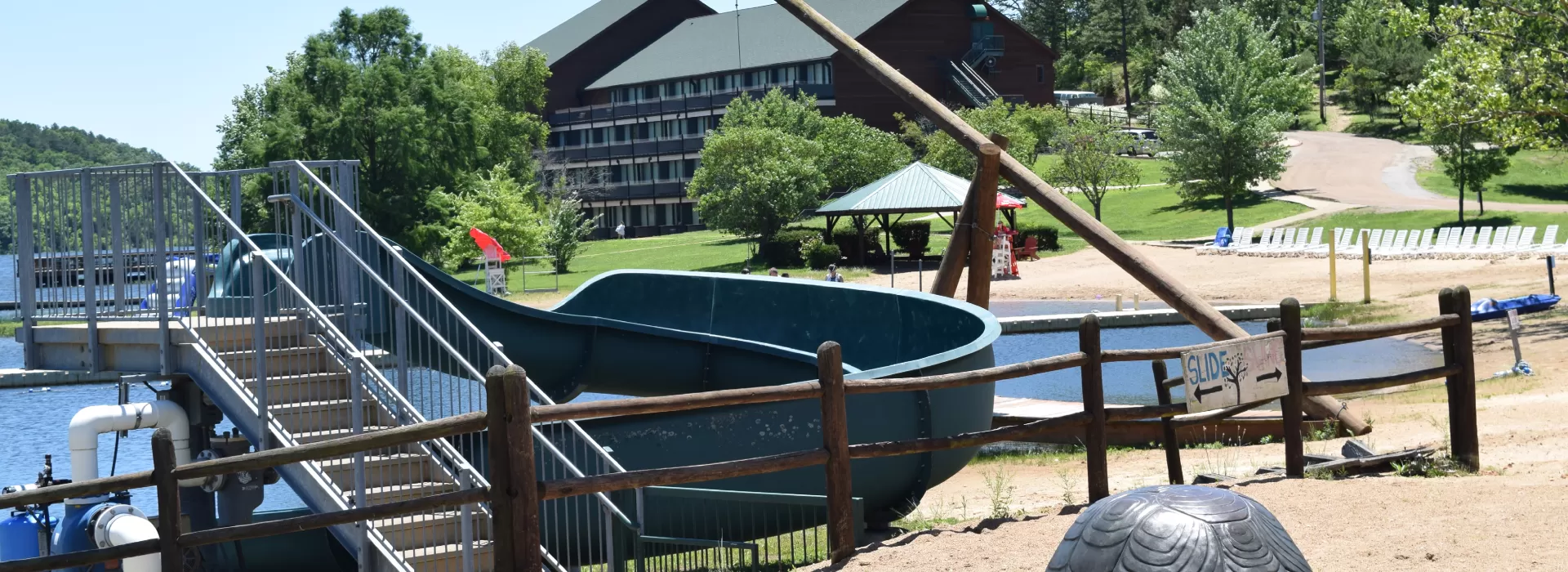 View of water slide and beach with lodge in the background
